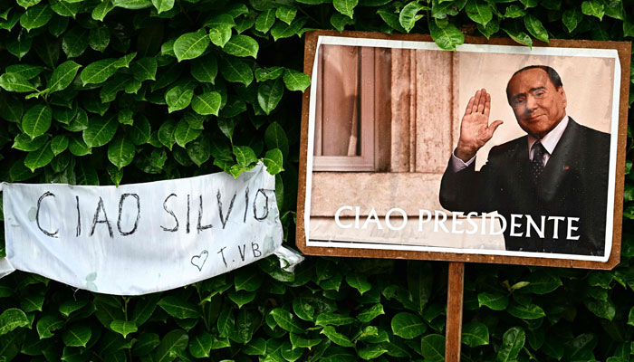This photograph shows a portrait of Silvio Berlusconi reading Good bye President outside the Villa San Martino, the residence of Berlusconi, following his death, in Arcore, northern Italy, on June 13, 2023. — AFP