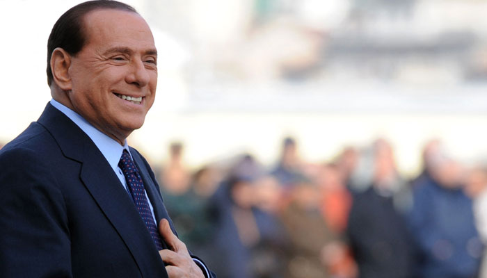 Former Italian Prime Minister Silvio Berlusconi arrives to greet German Chancellor Angela Merkel at Piazza Unita d´Italia prior to an Italy and Germany summit in Trieste. — AFP/File