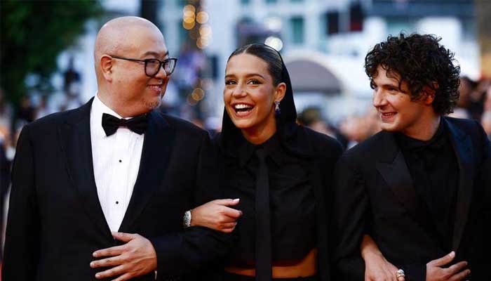 Director Peter Sohn and voice cast members Adele Exarchopoulos and Vincent Lacoste pose on the red carpet