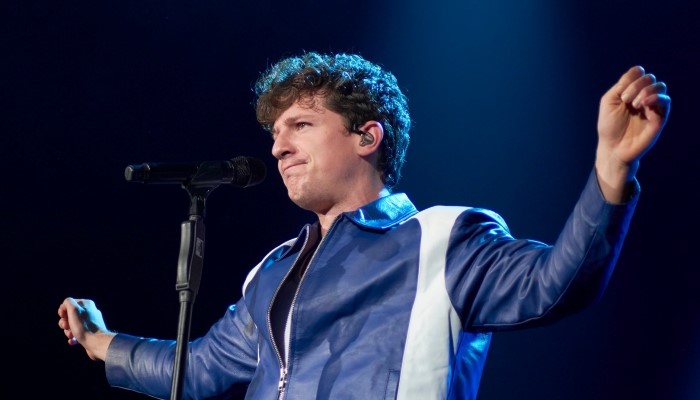 Charlie Puth reminisces about the night he and Meghan Trainor shared a kiss, revealing the off-camera moment