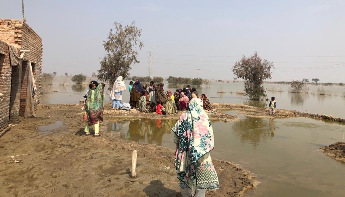 Women gather at a site in a flood-affected area to collect sanitary kits. — Mahwari Justice