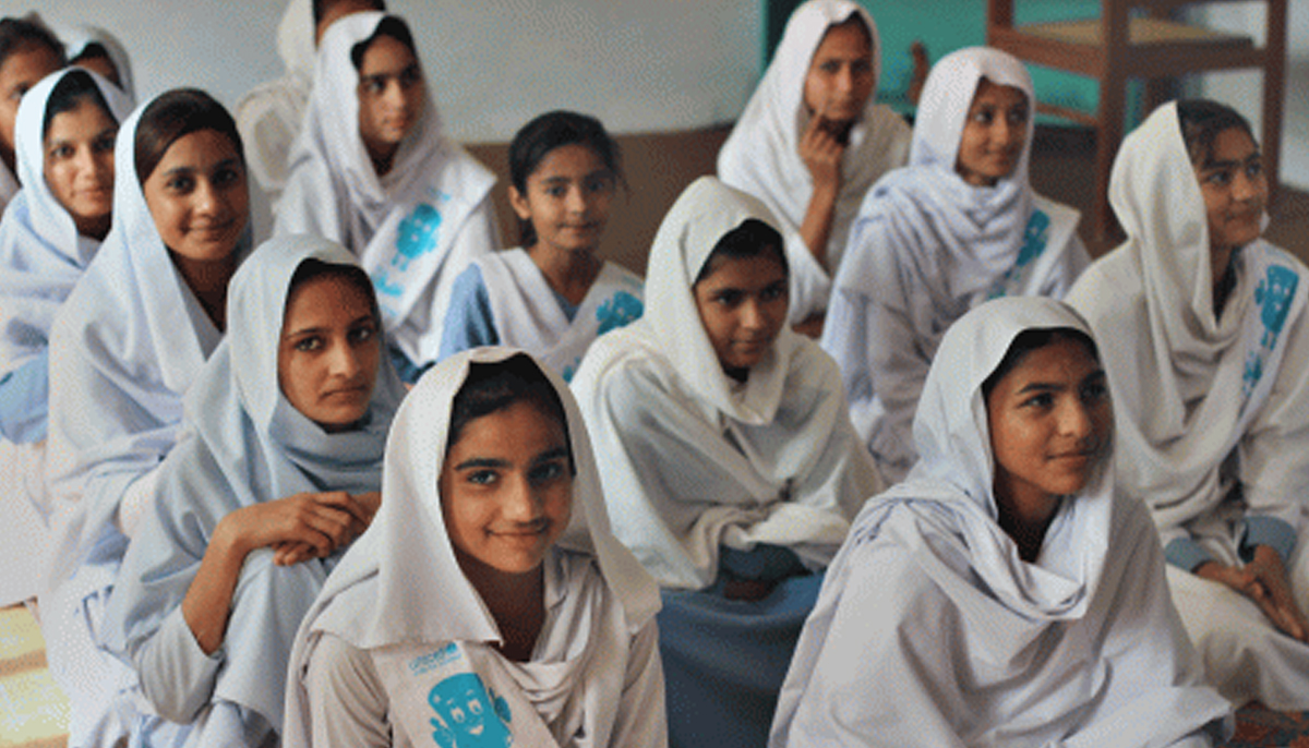 Schoolgirls seated during a menstrual education class. — UNICEF