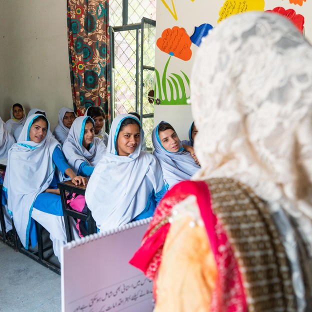 A teacher in a school teaches her female students regarding menstruation. — Water Aid