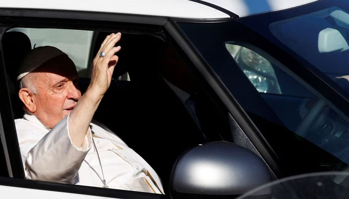 Pope Francis gestures as he rides in a car on the day of his discharge from Gemelli hospital in Rome, Italy, June 16, 2023. — Reuters
