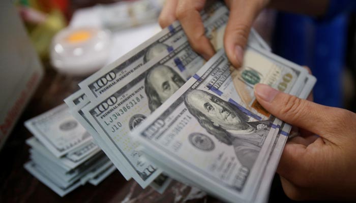 An employee of a bank counts US dollar notes at a branch in Hanoi, Vietnam May 16, 2016. — Reuters