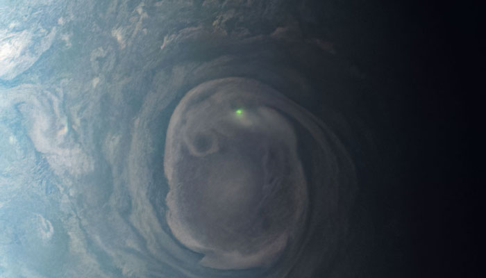 In this view of a vortex near Jupiter’s north pole, Nasas Juno mission observed the glow from a bolt of lightning on June 16, 2023. — Nasa