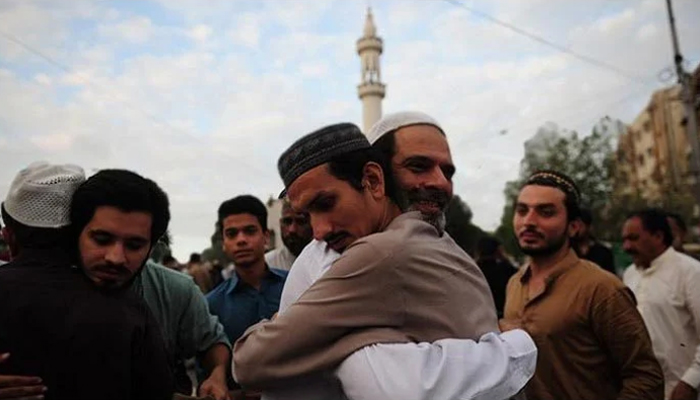 A representational image of people embracing each other after Eid prayers. — AFP/File