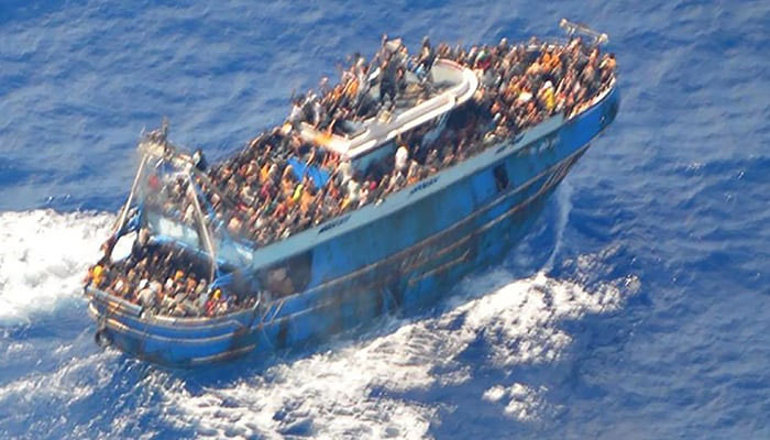 This image released by The Hellenic Coastguard on June 14, 2023, shows an aerial view taken from a rescue helicopter, of migrants onboard a fishing vessel in the waters off the Peloponnese coast of Greece on June 13, 2023. — AFP