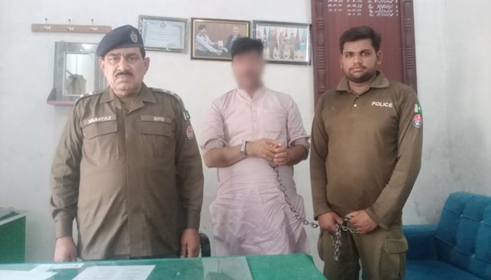 Two cops stand with the arrested suspect in a police station. — Twitter/ @OfficialDPRPP