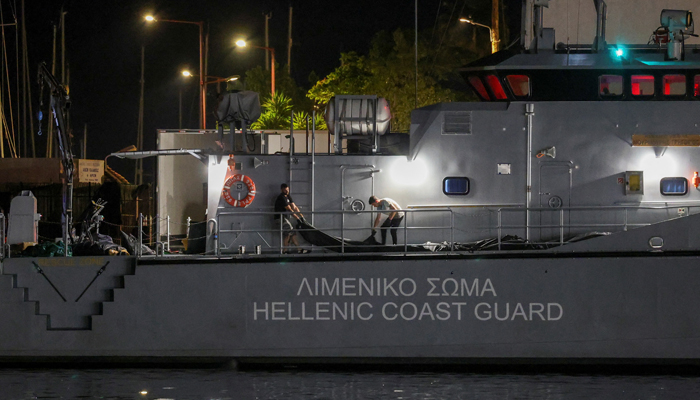 Men transfer body bags carrying migrants who died after their boat capsized in the open sea off Greece, onboard a Hellenic Coast Guard vessel at the port of Kalamata, Greece, June 14, 2023. — Reuters