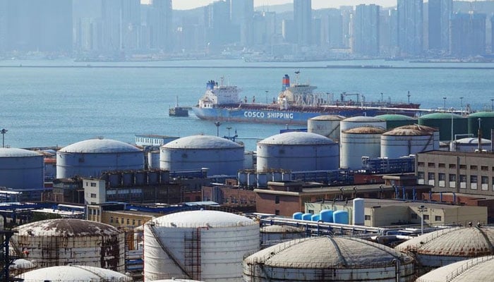 A China Ocean Shipping Company (COSCO) vessel is seen near oil tanks at the China National Petroleum Corporation (CNPC)s Dalian Petrochemical Corp in Dalian, Liaoning Province, China. — Reuters/File