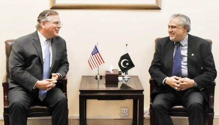 Minister for Finance and Revenue Senator Ishaq Dar (right) speaks to US Ambassador Pakistan Donald Blome in Islamabad, on June 21, 2023. — Twitter/@FinMinistryPak