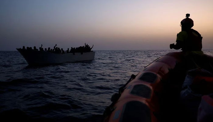 Migrants give signals to NGO Proactiva Open Arms Uno rescue boat in central Mediterranean Sea, August 17, 2022. — Reuters