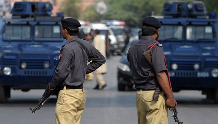 A representational image of two policemen patrolling in Karachi. — AFP