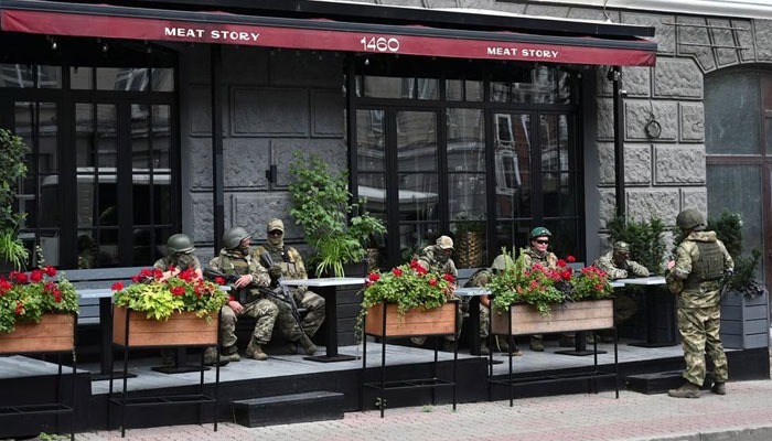 Fighters of Wagners private mercenary group rest in a cafe while being deployed in a street near the headquarters of the Southern Military District in the city of Rostov-on-Don, Russia. — Reuters