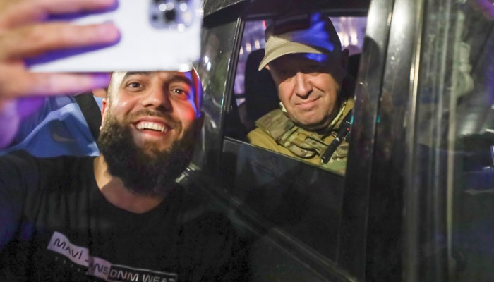 Wagners Prigozhin stops to take selfies with locals while departing Rostov. — Reuters