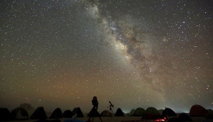 The Milky Way is seen in the night sky around telescopes and camps of people over rocks in the White Desert north of the Farafra Oasis southwest of Cairo. — Reuters/File