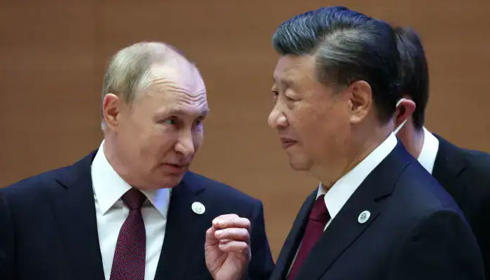 Russian President Vladimir Putin speaks to China’s President Xi Jinping during the Shanghai Cooperation Organization leaders’ summit in Samarkand on September 16, 2022. — AFP/File