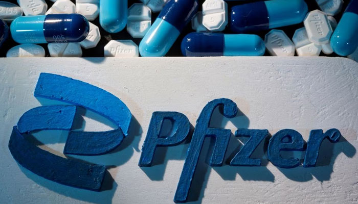 A 3D-printed Pfizer logo is placed near medicines from the same manufacturer in this illustration. — Reuters/File