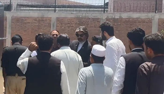 Police personnel rearrest Ali Muhammad Khan outside the jail in Mardan on June 9, 2023 in this still taken from a video. — Twitter/@PTIofficial