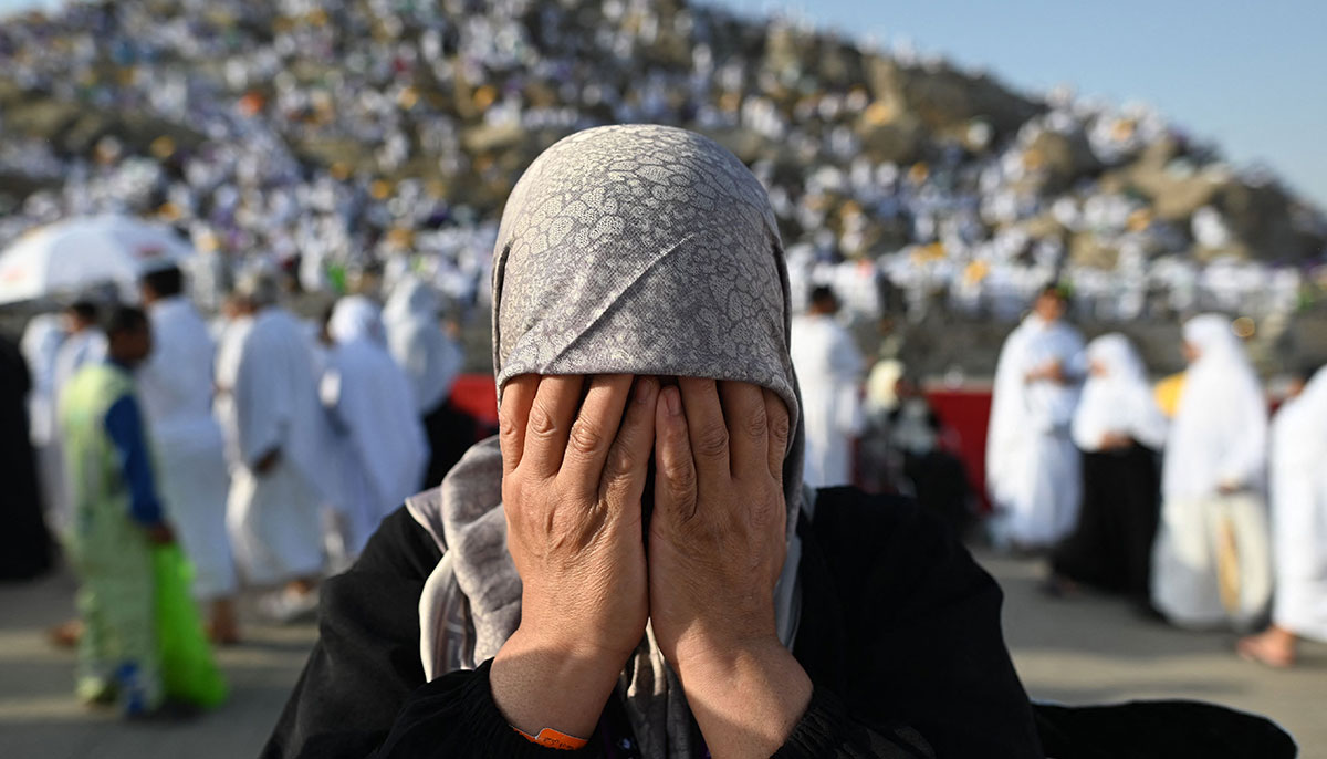 A pilgrim prays atop Mount Arafat, also known as Jabal al-Rahma or Mount of Mercy, during the climax of the Hajj pilgrimage on June 27, 2023. — AFP