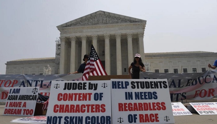 Opponents of affirmative action policies in university admissions which favor African-Americans demonstrate outside the US Supreme Court. — AFP