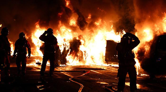 Macron calls crisis meeting as France protests continue for second night
