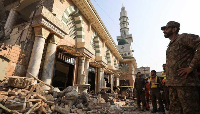An Army soldier and rescue workers survey the damages after the suicide blast that struck the Malik Saad Shaheed Mosque in the Police Lines area of Peshawar, Pakistan January 31, 2023. — Reuters