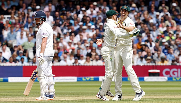 Australia´s Pat Cummins (R) and Australia´s wicket keeper Alex Carey (C) celebrate taking the wicket of England´s Jonny Bairstow for 10 runs on day five of the second Ashes cricket Test match between England and Australia at Lord´s cricket ground in London on July 2, 2023. — AFP