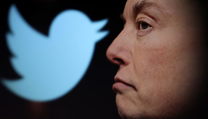 Twitter logo and a photo of Elon Musk are displayed through magnifier in this illustration taken October 27, 2022. — Reuters
