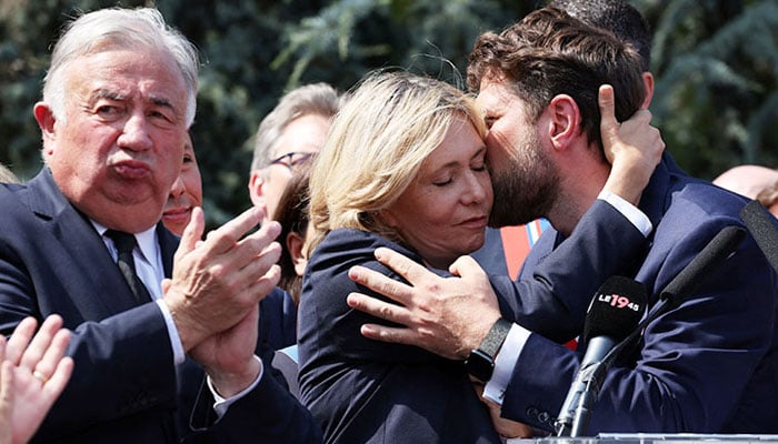 LHay-les-Roses Mayor Vincent Jeanbrun kisses Ile-de-France Region President Valerie Pecresse during a march in Paris on Monday. Reuters