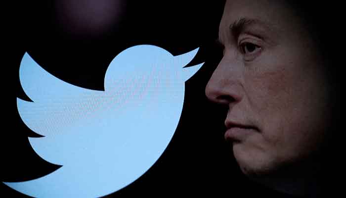 Twitter logo and a photo of Elon Musk are displayed through a magnifier in this illustration taken October 27, 2022. —Reuters
