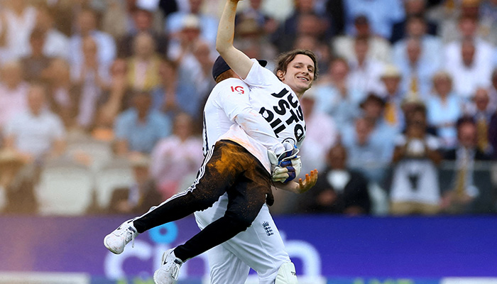Englands Jonny Bairstow carries a just stop oil protester off the field. — Reuters/File