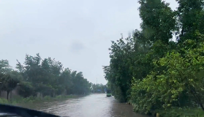 Heavy rainfall inundates a road in Lahore, on July 5, 2023, in this still taken from a video. — Twitter/AhmadWaleed