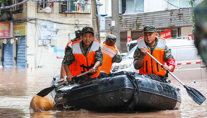 Paramilitary policemen search an area after it was flooded by heavy rains in China´s southwestern Chongqing on July 4, 2023. — AFP