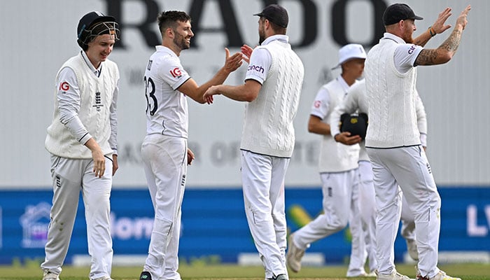 Mark Wood (2L) of England celebrates with teammates after being bowled by Todd Murphy of Australia on the first day of the 3rd Ashes Cricket Test match between England and Australia at Headingley Cricket Ground in Leeds, northern England on July 6, 2023. happened.-AFP