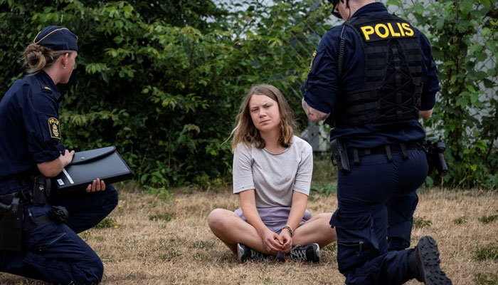 Police talk to Greta Thunberg as they escort climate activists from the organization Ta Tilbakka Framatiden blocking the entrance to Oljehamenen on June 19, 2023 in Malmö, Sweden. Reuters/File
