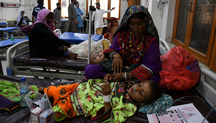 A woman, who became flood victim, takes care of her ailing baby at a hospital, following rains and floods during the monsoon season in Jamshoro, Sindh on September 20, 2022. — Reuters