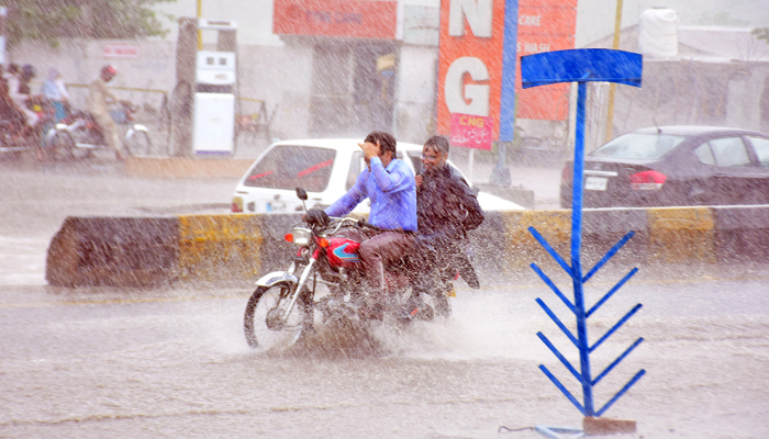 Motorists on Murree Road during heavy rainfall of Pre-monsoon spell in Islamabad on July 3, 2023. — Online