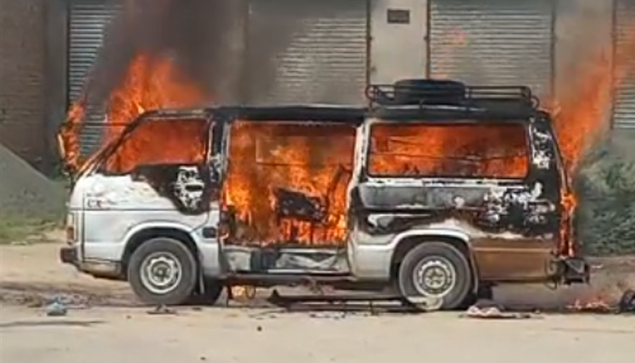 Van engulfed in flames after explosion seen in this screengrab of a video filmed on site of incident in Sargodha, on June 8, 2023. —  Reporter