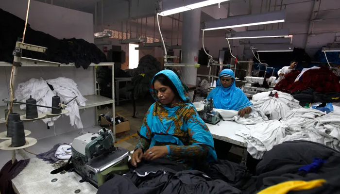 Female workers at a garment factory stitch together loose fabric. — Reuters/File
