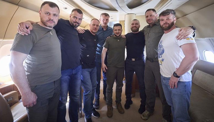 In this photo provided by the Ukrainian Presidential Press Office, frome left: Interior Minister Ihor Klymenko, defenders of the Azovstal steel plant Oleh Khomenko, Denys Shleha, Denys Prokopenko, Ukrainian President Volodymyr Zelenskyy, defender of the Azovstal Serhii Volynskyi, Head of the Presidential Office Andriy Yermak and deputy commander of the Azov regiment Svyatoslav Palamar pose for the picture inside a plane during their flight from Turkey to Ukraine, Saturday, July 8, 2023.President Office