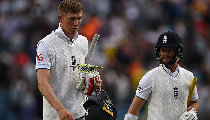 England´s Zak Crawley (L) and England´s Ben Duckett walk off the ground at the end of day three of the third Ashes cricket Test match between England and Australia at Headingley cricket ground in Leeds, northern England on July 8, 2023.