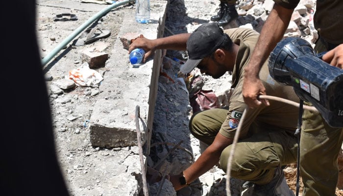 Policemen are engaged in search operation after a gas cylinder blast in a hotel in Jhelum. - @police_jhelum