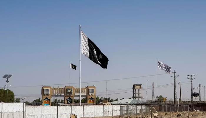 General view of Pakistans flag and the Talibans flag in the background as seen from the Friendship Gate crossing point in the Pakistan-Afghanistan border town of Chaman, Pakistan August 12, 2021. — Reuters