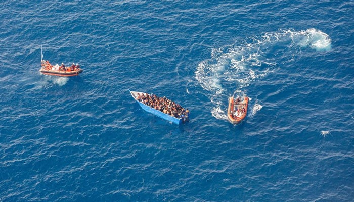 Members of the German charity Sea-Watch 3 rescue ship team help migrants on a wooden boat during a rescue operation in the Mediterranean Sea, February 26, 2021. — Reuters