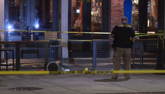 A police officer can be seen conducting an investigation on the crime scene after a mass shooting incident in Cleveland, Ohio, on July 9, 2023. — Screengrab/YouTube/WKYC Channel 3