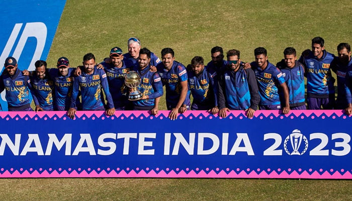 Sri Lanka’s players pose with the World Cup Trophy after their victory during the ICC Men´s Cricket World Cup Qualifier Zimbabwe 2023 Final cricket match between Sri Lanka and Netherlands at Harare Sports Club in Zimbabwe on July 9, 2023. — AFP