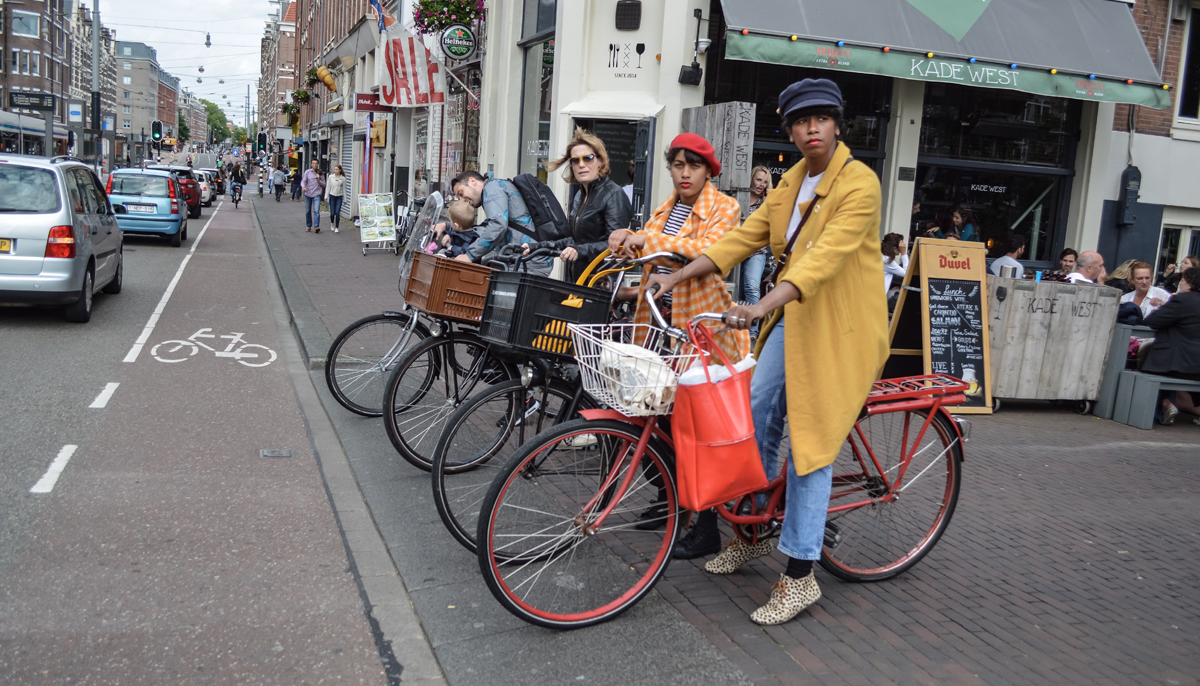 Women await with their bicycles at a signal in Amsterdam, Netherlands. — Dutch Cycling Embassy