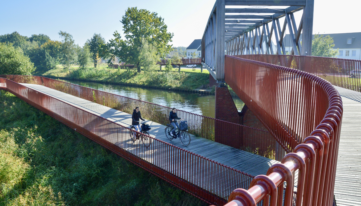 Women seen cycling on a dedicated cycle bridge in Oirschot, a municipality in the Netherlands. — Dutch Cycling Embassy